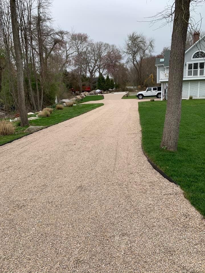 Finished driveway installed by Clark and Company leading up to a new garage foundation