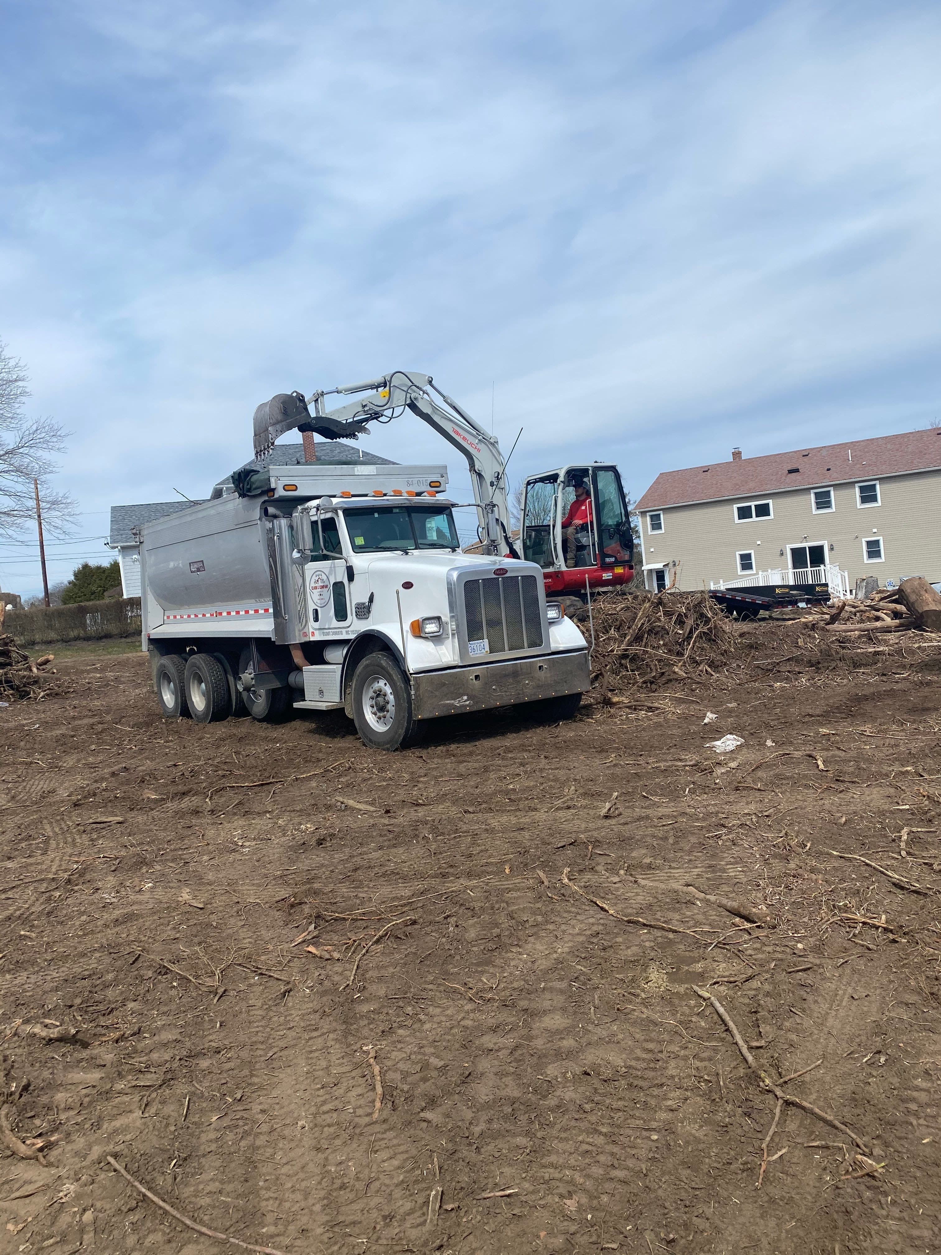 Clark and Company using our Tri-Axle dump truck to remove debris